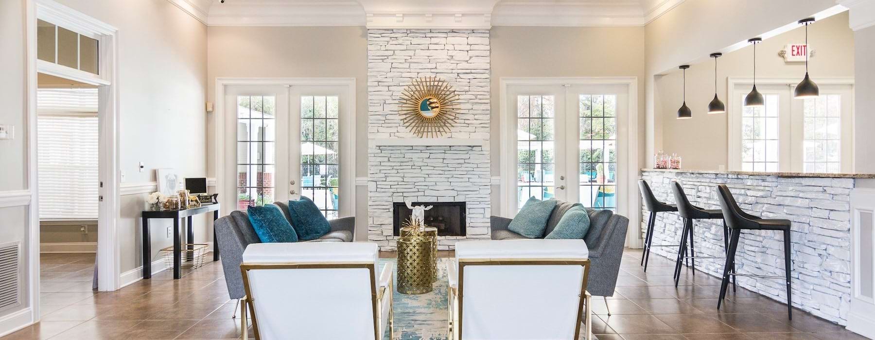 a large room with a fireplace and an island