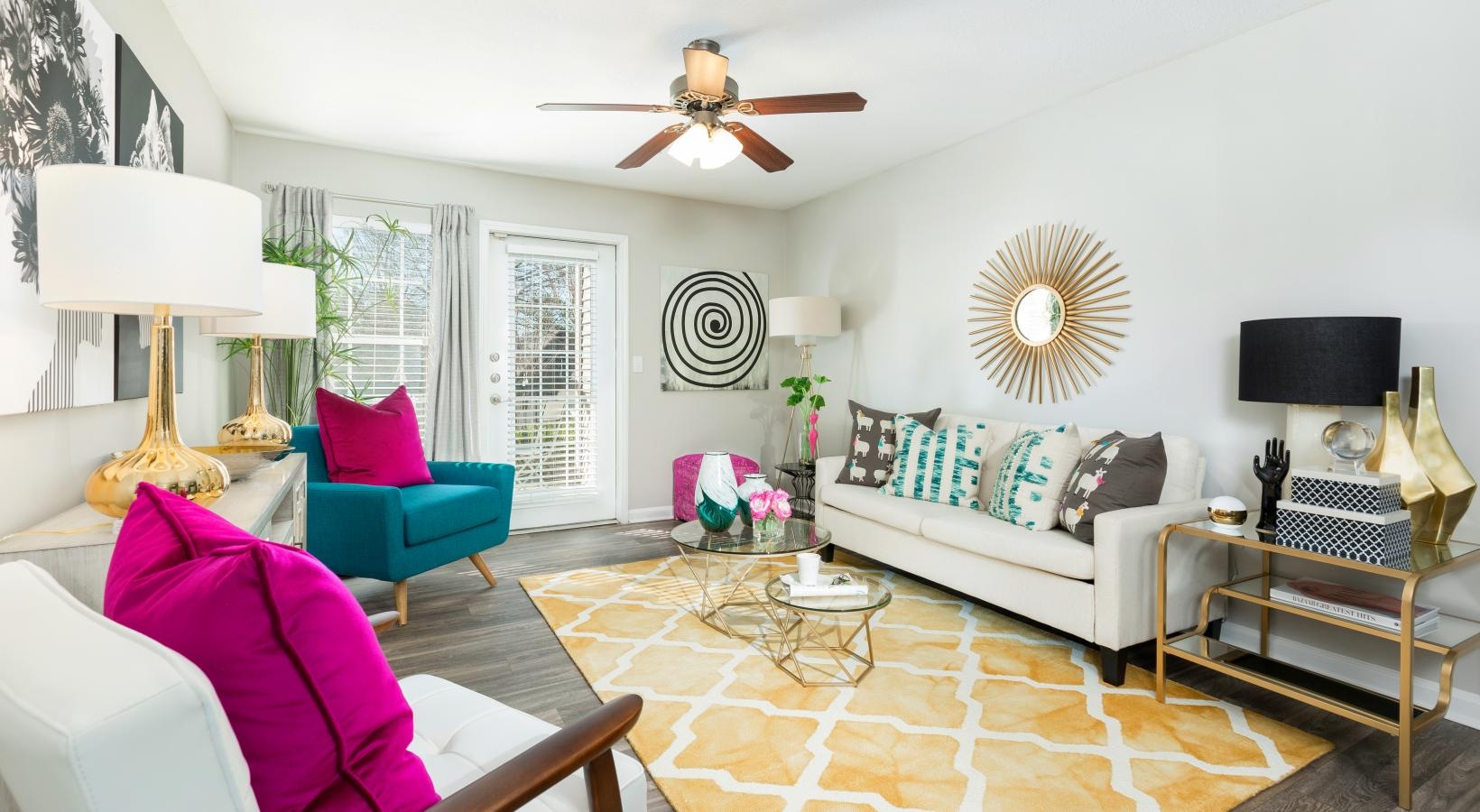 a living room with a couch and a fan